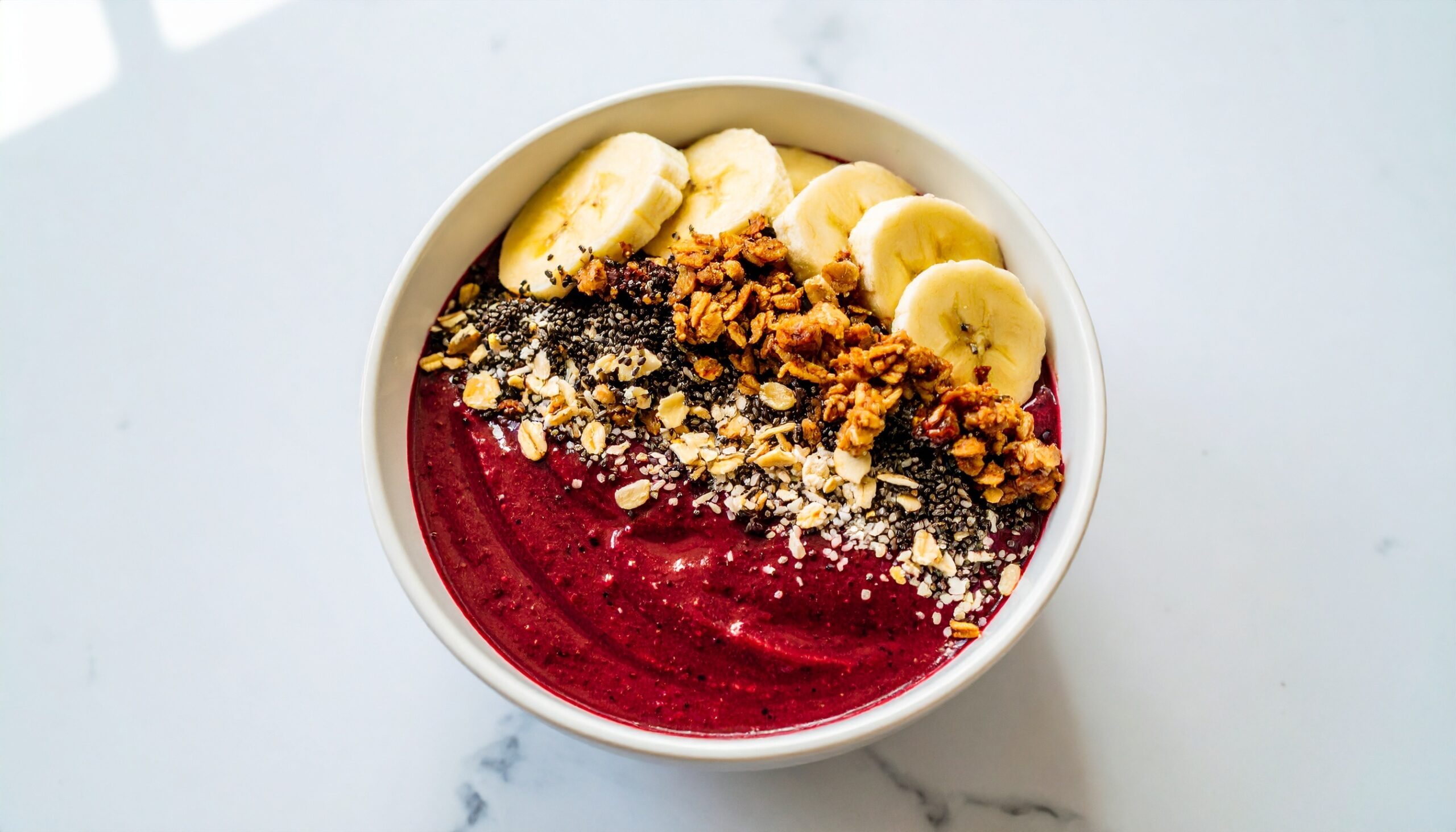 Frozen açaí (ah-sah-EE) berry blended thick and topped with granola, banana, and honey.