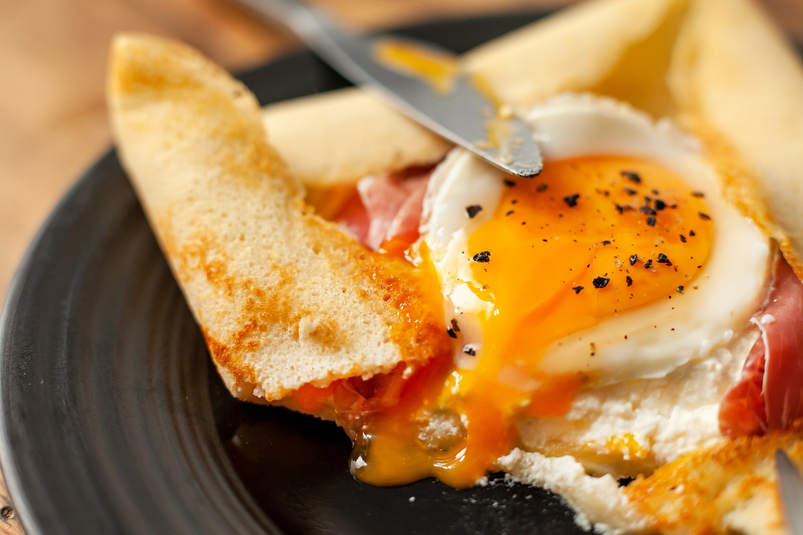Ham and cheese crepes with a side of fruit salad