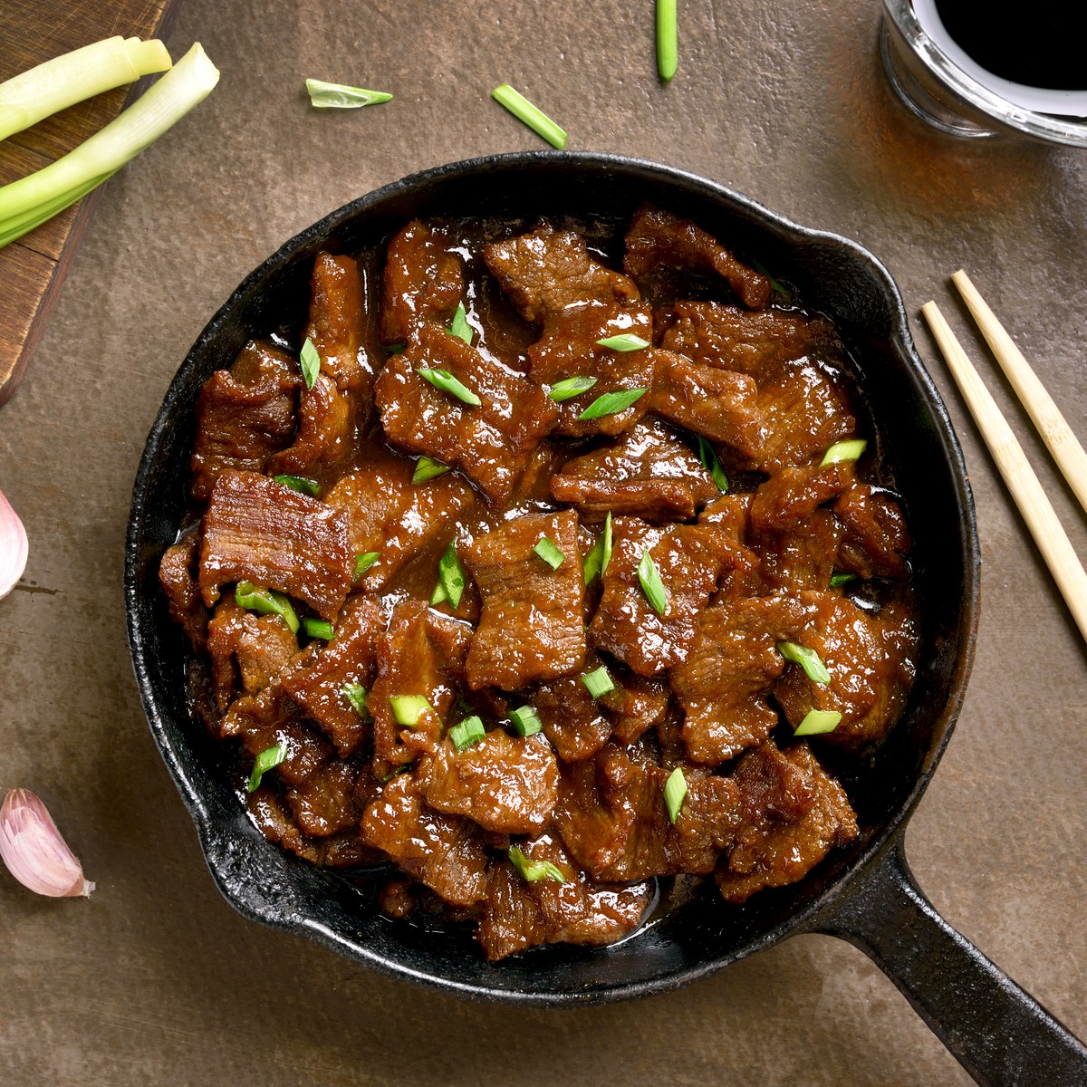 Tender beef slices in a glossy brown sauce, garnished with sliced green onions