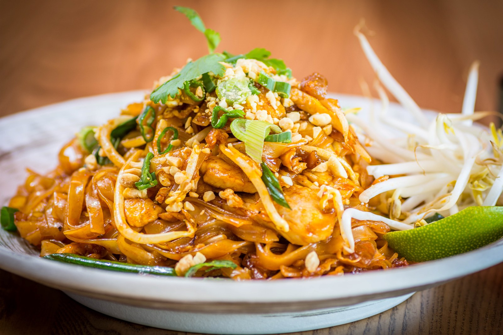 Pad thai noodles with shrimp, peanuts, bean sprouts, lime, and cilantro
