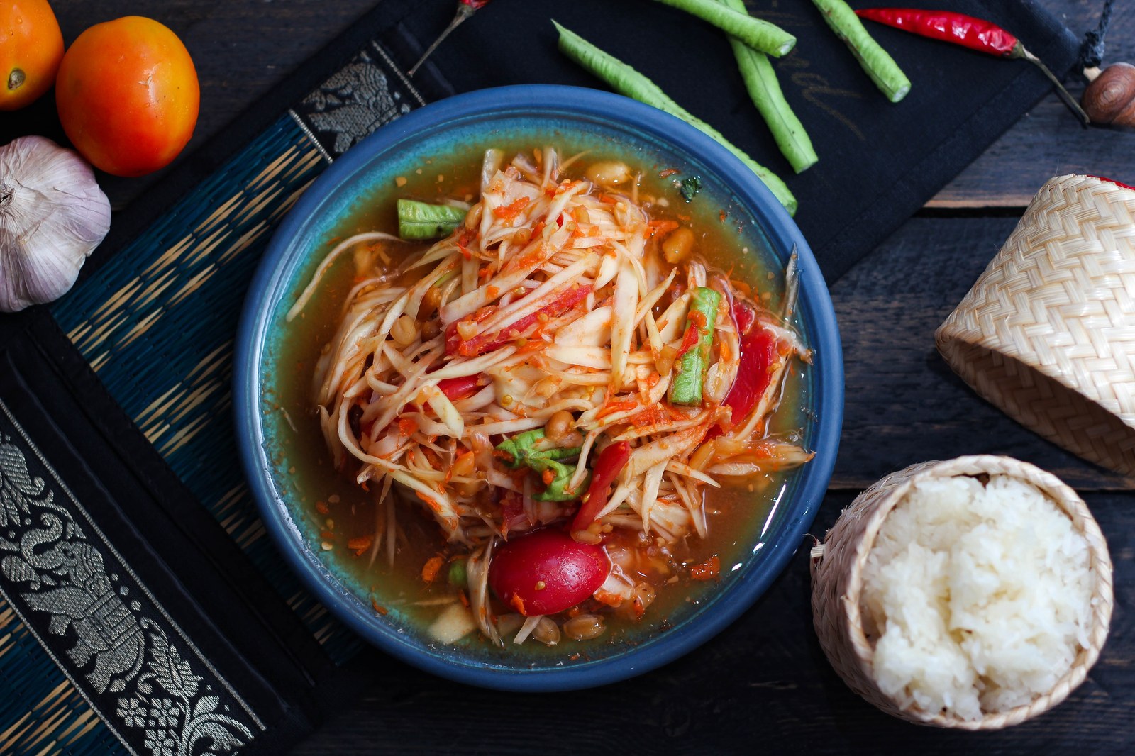 Thai green papaya salad (Som Tum) on a rustic plate